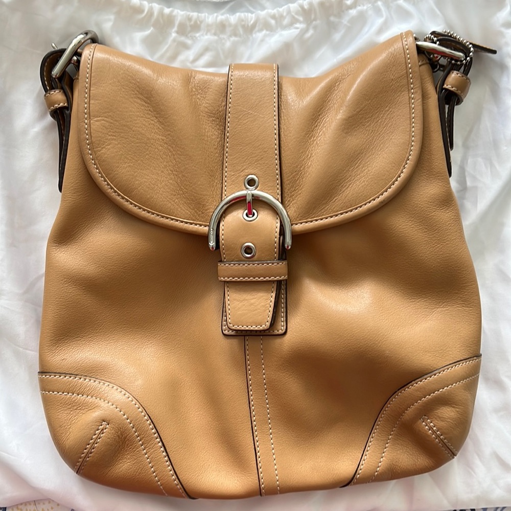 Beige Crossbody Coach shoulder bag with snap front closure